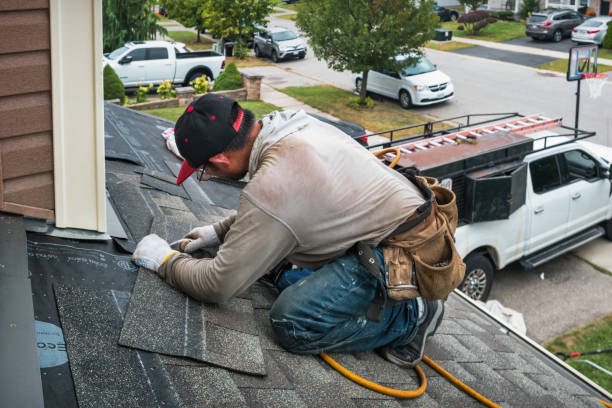 Professional Roofing technician working in Wellston, MO